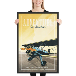 Retro style giclée art print of a modified WACO Biplane ready for takeoff. It has the words “Adventure in Aviaton” at the top. The print’s dusty yellow sunrise colors combined with bright blues and orange of the plane makes for a stunning image. There are additional words a the bottom that says “Sport biplanes for free spirits. Go Anywhere, Any Time.” Framed size 24" x 36''