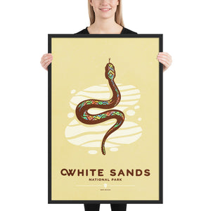 Modern, minimalist giclée art print of White Sands National Park & Preserve in Alaska. This simple and classy poster depicts a Diamondback Rattlesnake slithering across the white sands of the park. It has the words “White Sands National Park, New Mexico”  at the bottom. The print’s muted overall background color allows the bold and vibrant colors of the main image to pop. 