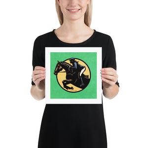Minimalist jumping equestrian art print captures the excitement of English riding events with its’ bold colors and simple, strong lines. It is a square pint with an image of a horse and rider jumping through a graphic circle. Green Background.
