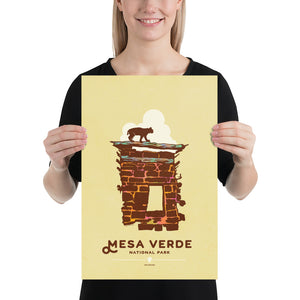 Modern, minimalist giclée art print for Mesa Verde National Park in Colorado. This simple and classy poster depicts a section of the ruins of Mesa Verde with a bobcat walking across the top of it.  It has the words “Mesa Verde National Park, Colorado” at the bottom. The print’s muted overall background color allows the bold and vibrant colors of the main image to pop.  print size 12'' x 18"