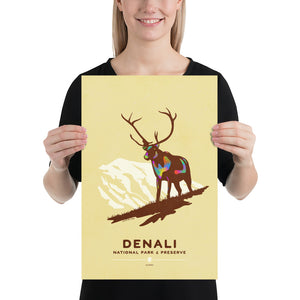 Modern, minimalist giclée art print of Denali National Park & Preserve in Alaska. This simple and classy poster depicts a Caribou standing on a hill top with the mountains in the background.  It has the words “Denali National Park & Preserve, Alaska”  at the bottom. The print’s muted overall background color allows the bold and vibrant colors of the main image to pop. 