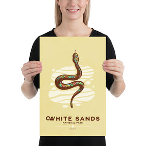 Modern, minimalist giclée art print of White Sands National Park & Preserve in Alaska. This simple and classy poster depicts a Diamondback Rattlesnake slithering across the white sands of the park. It has the words “White Sands National Park, New Mexico”  at the bottom. The print’s muted overall background color allows the bold and vibrant colors of the main image to pop. 