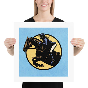 Minimalist jumping equestrian art print captures the excitement of English riding events with its’ bold colors and simple, strong lines. It is a square pint with an image of a horse and rider jumping through a graphic circle. Blue background.