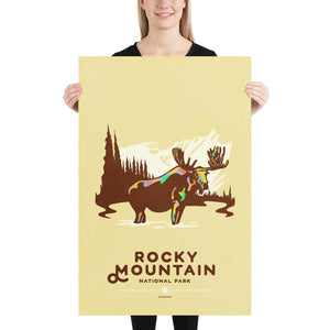 Modern, minimalist giclée art print for Rocky Mountain  National Park in South Dakota. This simple and classy poster depicts a moose standing in a lake with forest and mountains in the background.  It has the words “Rocky Mountain National Park, Colorado”  at the bottom. 