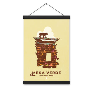 Modern, minimalist giclée art print for Mesa Verde National Park in Colorado. This simple and classy poster depicts a section of the ruins of Mesa Verde with a bobcat walking across the top of it.  It has the words “Mesa Verde National Park, Colorado” at the bottom. The print’s muted overall background color allows the bold and vibrant colors of the main image to pop. Print with hanger size 12" x 18"