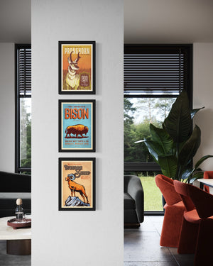 Vertical arrangement of three framed Western animal posters featuring pronghorn, bison, and bighorn sheep in a modern interior
