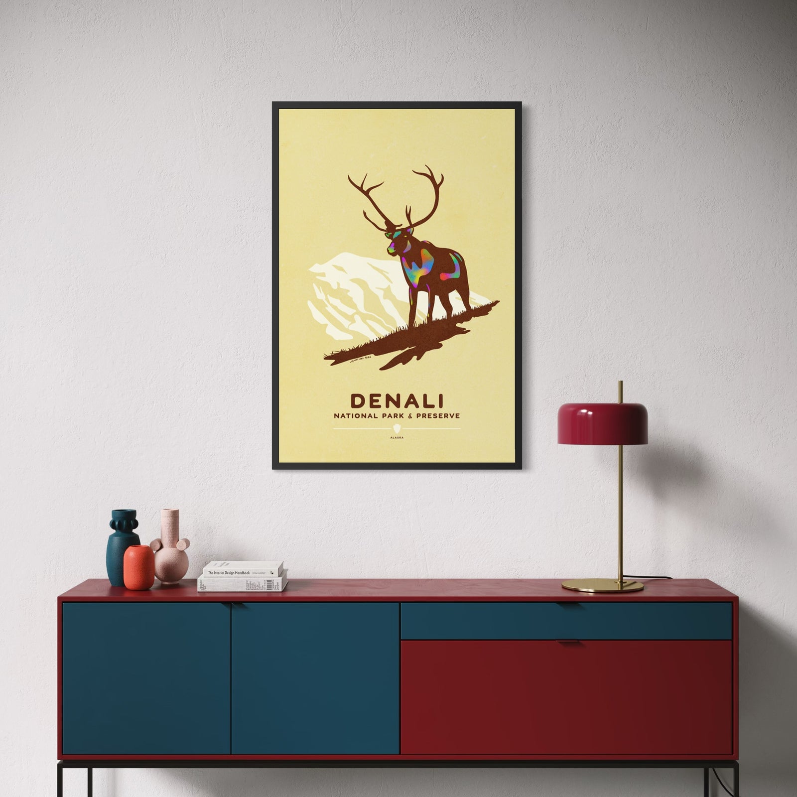Denali National Park poster featuring a caribou standing before the silhouette of Denali in a vintage-inspired Alaska travel poster design.