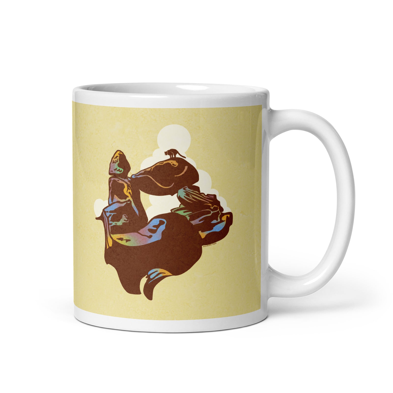 Coffee mug with an image of Balanced Rock in Big Bend with a Mountain Lion perched on top, and the words “Big Bend National Park, Texas” on the other.