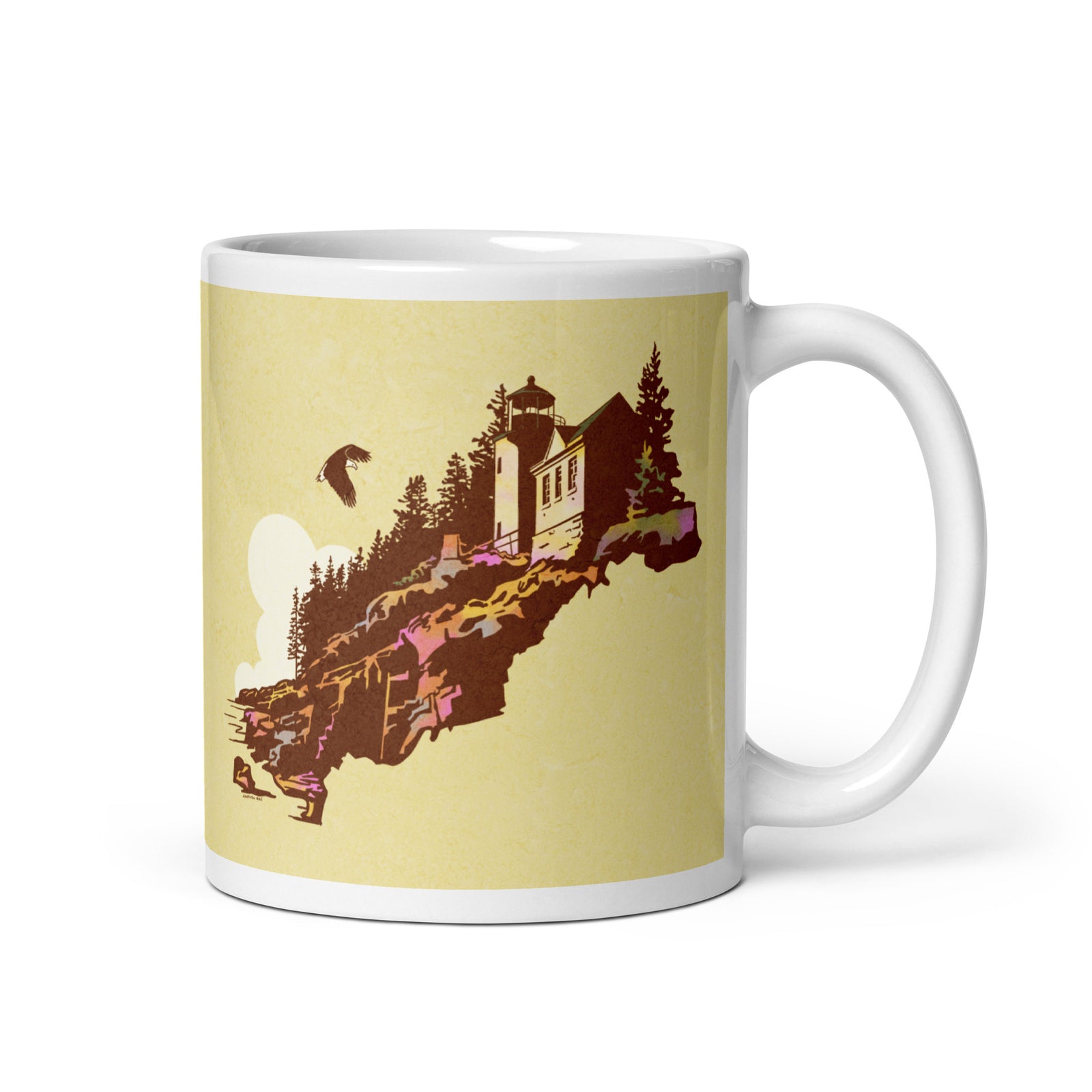 Coffee mug with an image of the historic Bass Harbor Head Light Station—with a Bald Eagle flying overhead on one side, and the words “Acadia National Park, Maine” on the other.