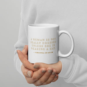 Coffee mug with a portrait of a woman’s royal wedding hat with Virginia Graham quote on the other side. 