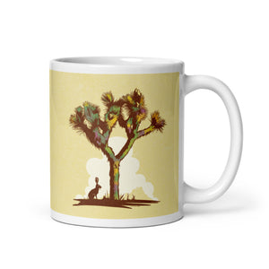 Coffee mug with an image of a Joshua Tree with a lone Jackrabbit sitting under its’ shade on one side and the words “Joshua Tree National Park, California” on the other side.