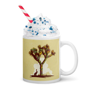 Coffee mug with an image of a Joshua Tree with a lone Jackrabbit sitting under its’ shade on one side and the words “Joshua Tree National Park, California” on the other side.