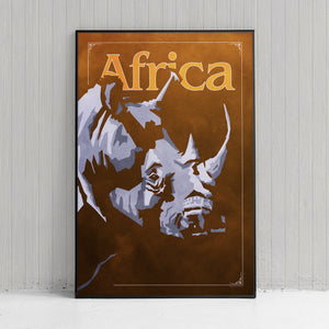 Bold graphic giclée art print of an African Rhinoceros. Print shows an African Rhino blending into a dark background and overlapping the word “Africa”.