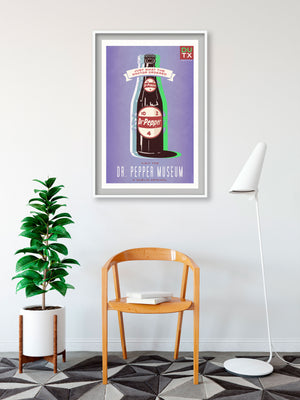 Bold graphic giclée art print of a Dr Pepper with the words “Visit the Dr Pepper Museum”. Print is predominately bright purple with large bottle of Dr Pepper on it.