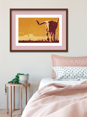 Modern style giclée art print of a longhorn in the field behind a farmhouse. It is brightly colored, yet has gritty texture overall. There is farmhouse, barn and windmill in the background
