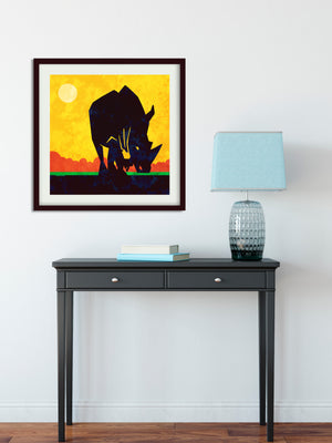 Primitive art print of an African Rhinoceros on the savannah created in a mid-century modern style with bold gold, red, green and black colors.
