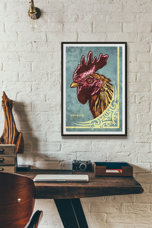 Bold graphic giclée art print of a Rooster. Print is a portrait of a Rooster next to a beautiful graphic ornament on a Blue Green background with the word “Rooster” below.