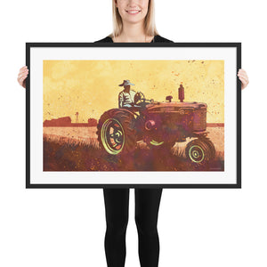 Modern style giclée art print of an old Tractor in a field. It is brightly colored, yet has gritty texture overall. There is a field and farm house with barn in the background. Framed Print Size 36" x 24"