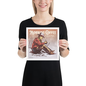 Bold graphic giclée art print of a Cowboy drinking coffee with the words “Morning Coffee”. Print is an ink portrait, with color, of a cowboy seated on the grounded with a cup of coffee in hand.  Size 10" x 10"
