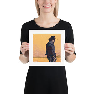 Modern style giclée art print of a western gunslinger. It features dusty sunset colors and gritty texture with a minimalist western landscape in the background. Size 10" x 10"