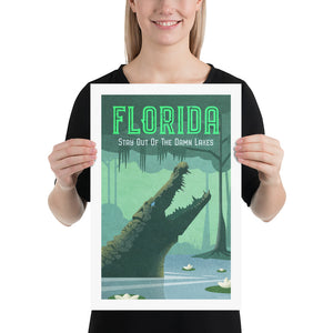 Humorous giclée art print travel poster of Florida showing an alligator in a lake with floating flowers and trees with moss.