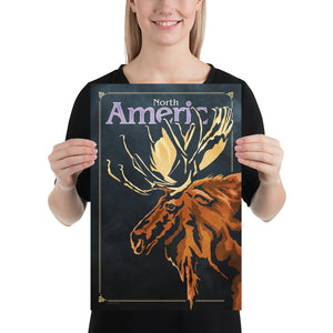 Bold graphic giclée art print of a North American Moose. Print shows a North American Moose blending into a dark gray Bluegreen background and overlapping the words “North America”. Size 12" x 18"