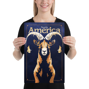 Bold graphic giclée art print of a North American Bighorn Sheep. Print shows a North American Bighorn Sheep blending into a dark blue background and overlapping the words “North America”. Size 12" x 18"