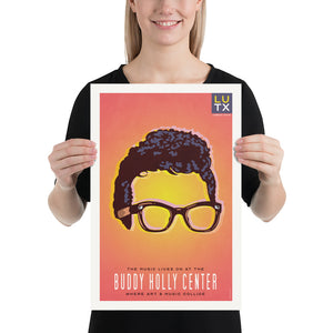Bold graphic giclée art print of the iconic glasses and hair of Buddy Holly with the words “The Music Lives on at the Buddy Holly Center”. Print has a orange to yellow background with shades of blue. Size 12" x 18"
