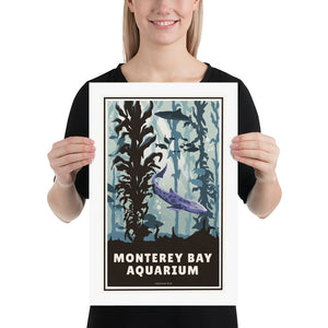A retro style giclée art print of the Monterey Bay Aquarium in California. It has the words “Monterey Bay Aquarium” on the bottom. The print primarily is in bold aquas and purples with sharks and fish in the kelp forrest exhibit. Size 12" x 18"